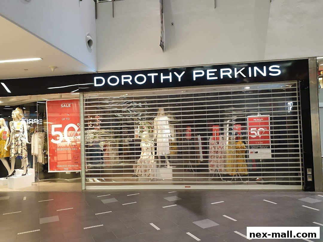 The exterior of a Dorothy Perkins store with mannequins and sale signs visible.