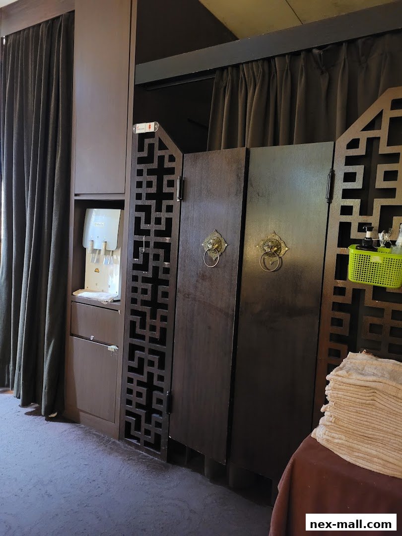 Interior view of Chen Kang Wellness NEX with wooden doors and decorative screens.