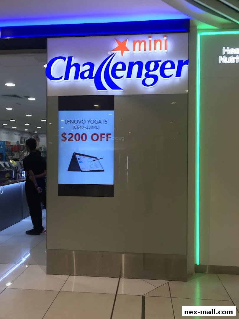 Challenger NEX shop front with a digital display advertising a Lenovo Yoga laptop.