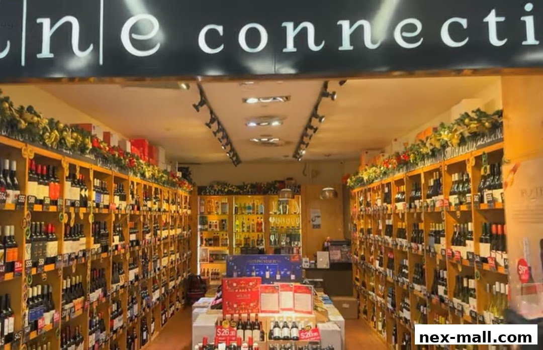 Interior view of a well-stocked wine shop with shelves full of wine bottles and festive decorations.