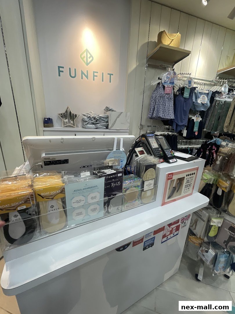 The FUNFIT shop counter displays various apparel items and accessories, including socks and tights.