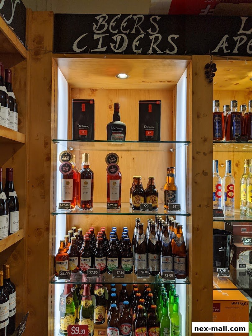 A display of various alcoholic beverages including wine, beer, and spirits on shelves.