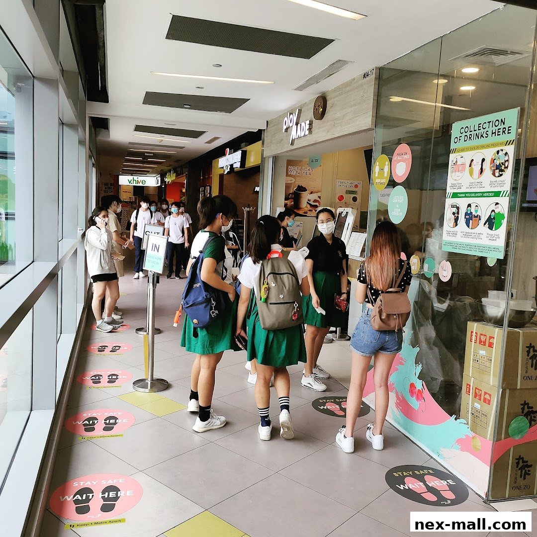 People queueing outside a PlayMade shop with social distancing markers on the floor.