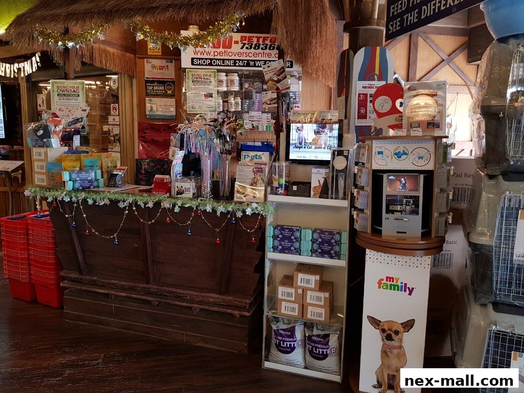 Interior view of a pet supply store with a counter, shelves of products, and promotional displays.