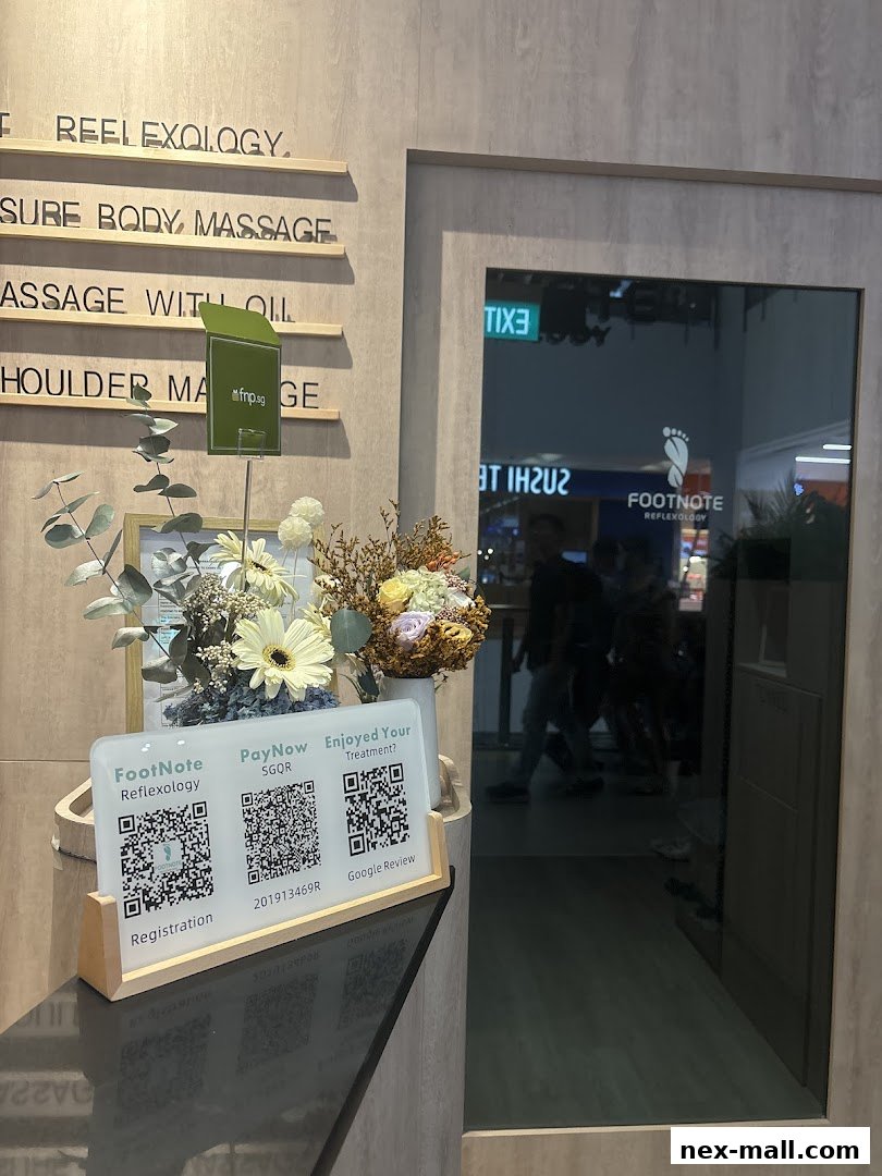 The entrance to FootNote Reflexology with service descriptions and QR codes for registration and reviews.