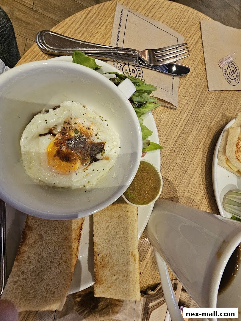 A breakfast spread with a fried egg, salad, toast, and coffee at The Coffee Bean & Tea Leaf.