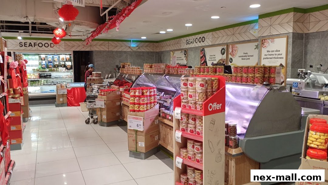 Interior view of a Cold Storage supermarket with seafood and meat sections, featuring promotional displays.