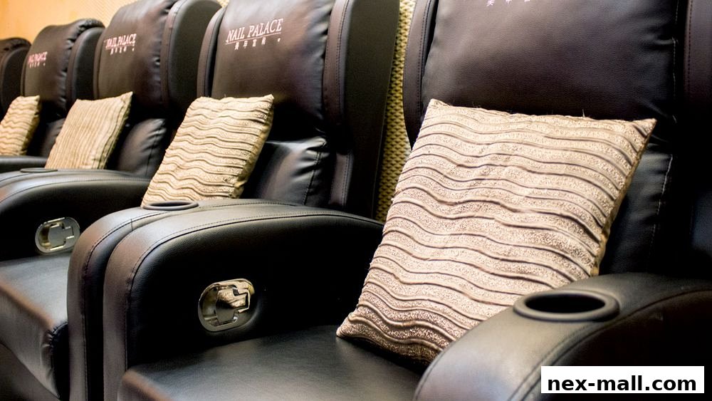 Comfortable black leather chairs with decorative pillows and cup holders.