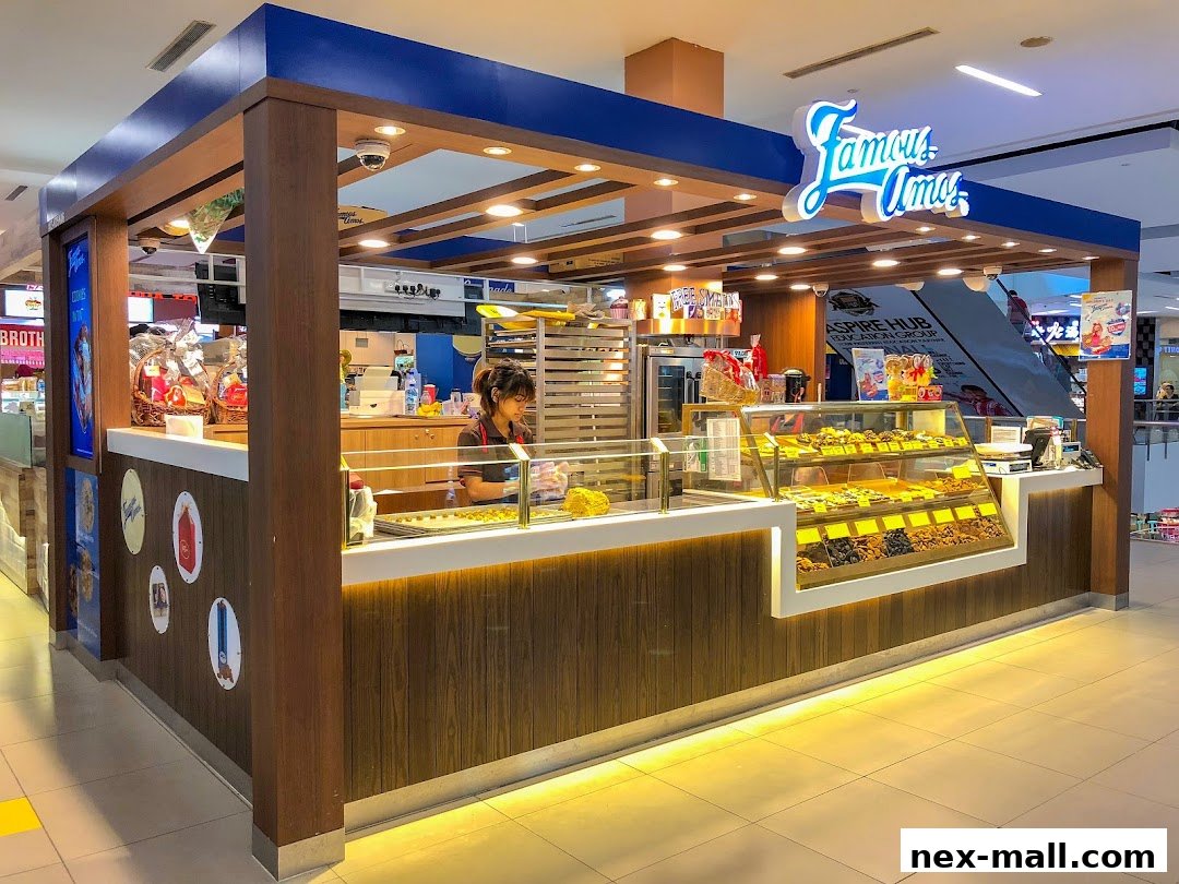 A Famous Amos cookie store counter with a variety of cookies displayed in a glass case.