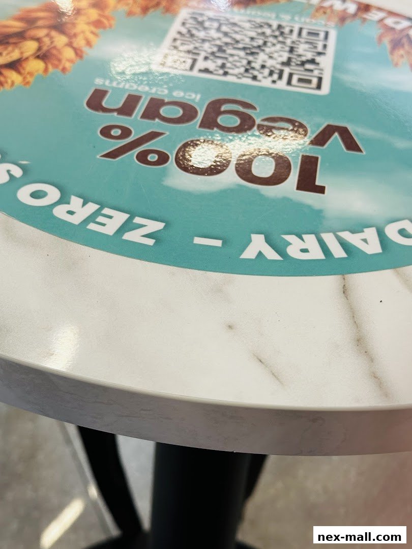 A table with a circular sign promoting 100% vegan, zero dairy ice creams.