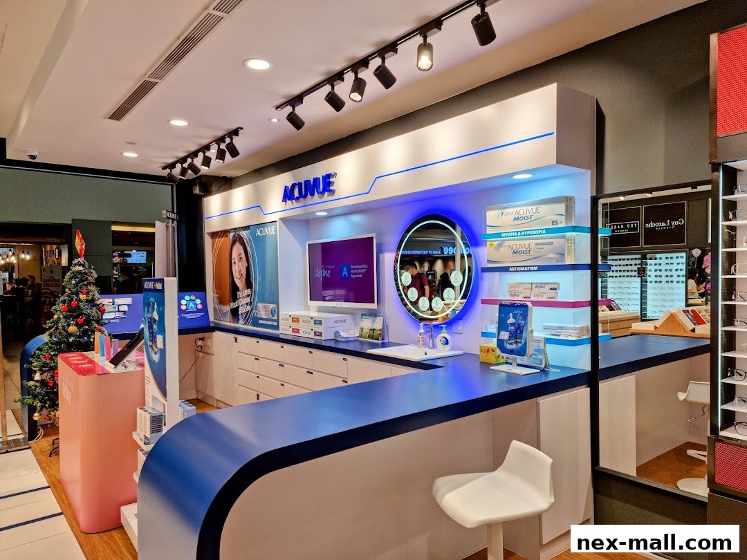 Interior view of an optical shop with contact lenses and eyewear displays, featuring a Christmas tree.