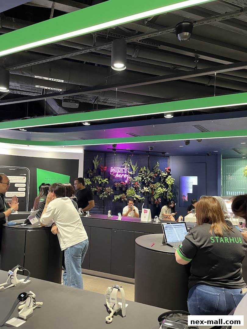 Customers interact with staff inside a modern StarHub store with a green and black color scheme.