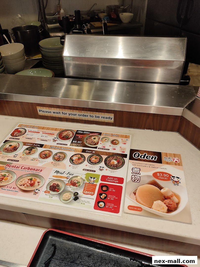 A menu display for Idaten Udon featuring various udon dishes, dons, and oden.