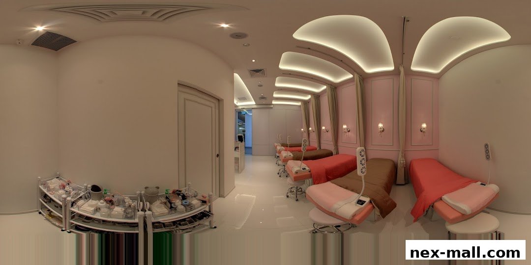 Interior view of a clean and modern eyelash extension salon with multiple treatment beds.