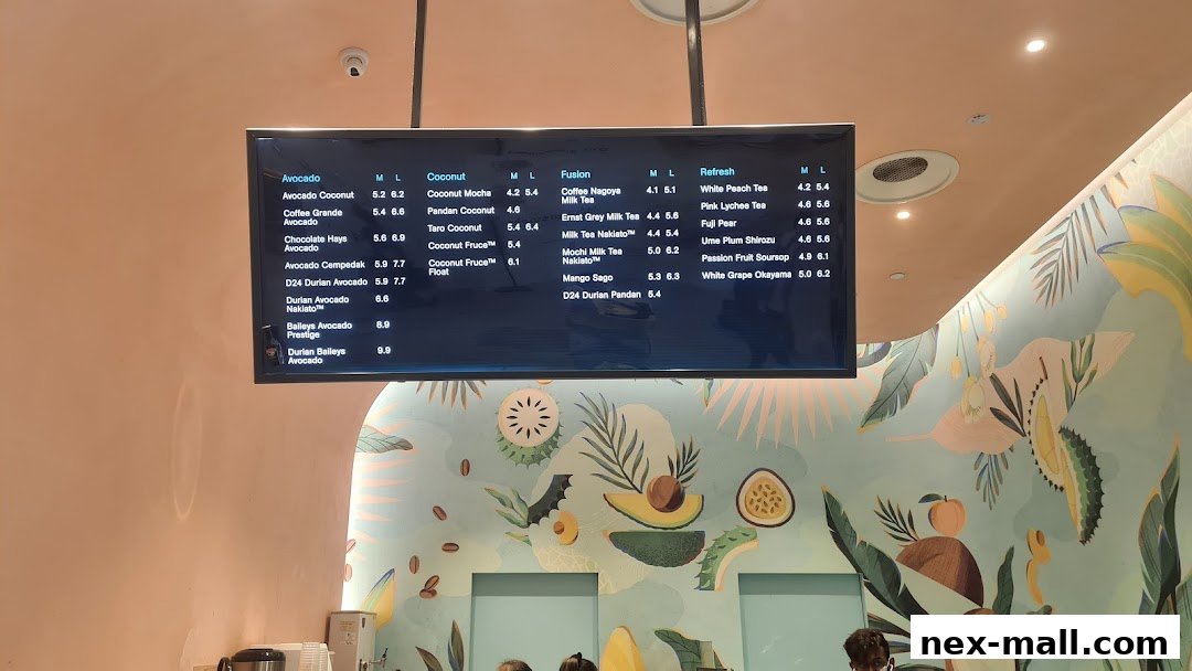 A digital menu board displaying various drinks with prices for different sizes.