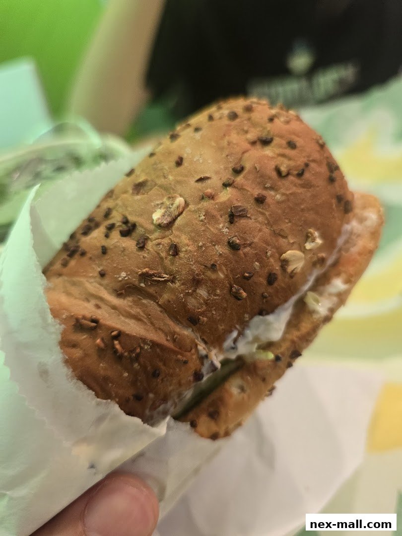 A close-up shot of a Subway sandwich with multi-grain bread and visible fillings.
