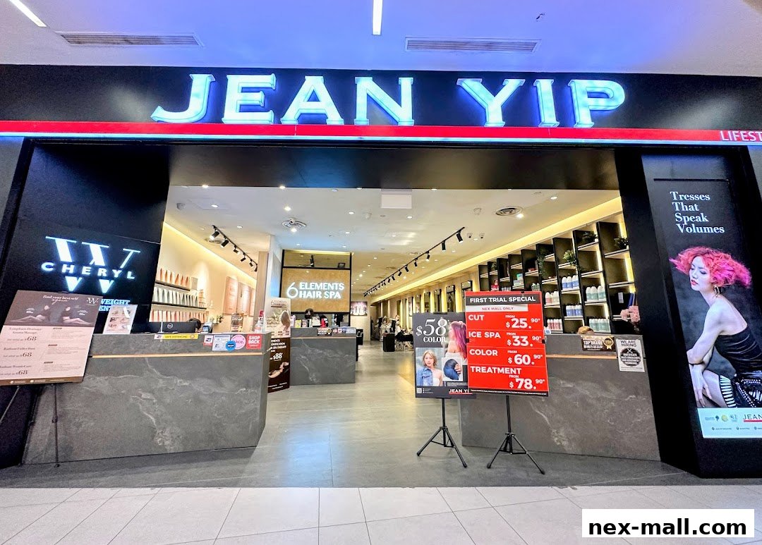 The entrance of Jean Yip Hairdressing NEX, showcasing a modern salon interior and promotional offers.