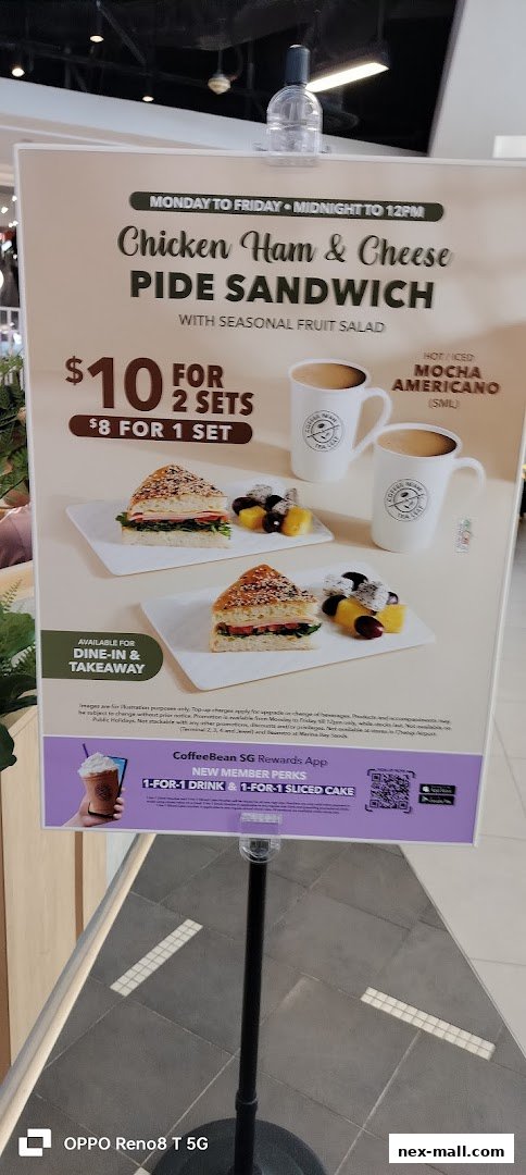 A promotional sign for The Coffee Bean & Tea Leaf featuring a sandwich and coffee deal.