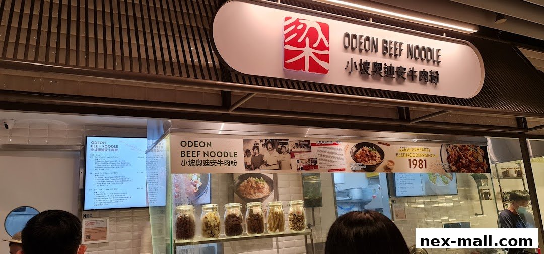 Odeon Beef Noodle shop front with menu display and historical photos.