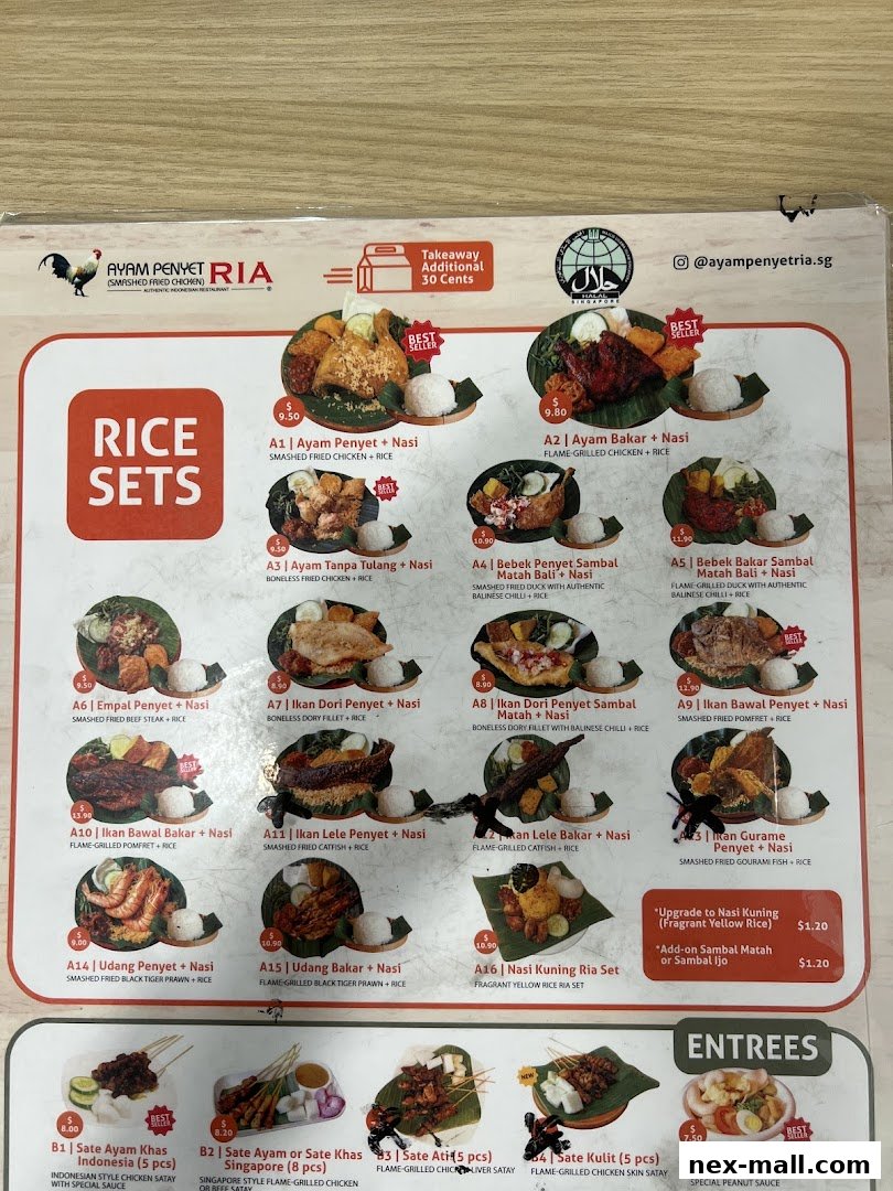 A menu from Ayam Penyet Ria featuring various rice sets and entrees with prices.