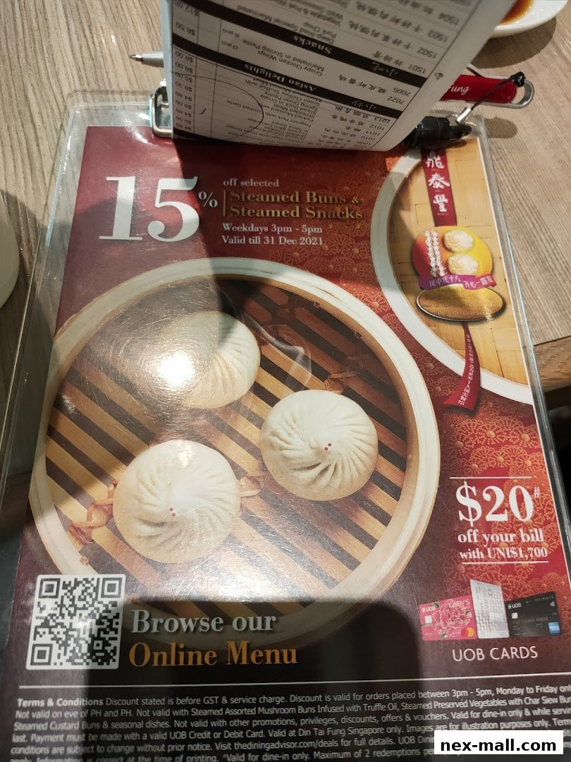 A menu from Din Tai Fung featuring steamed buns and snacks, with a 15% discount offer.