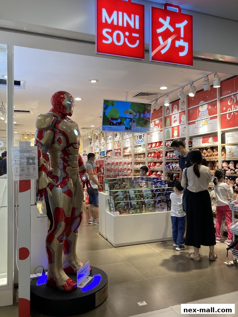 MINISO NEX store entrance featuring an Iron Man statue and various merchandise.