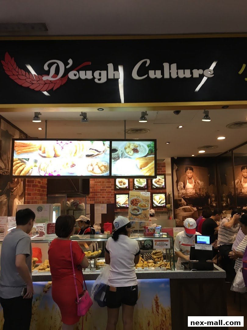 Customers queue at Dough Culture, a food stall displaying various fried snacks and pastries.