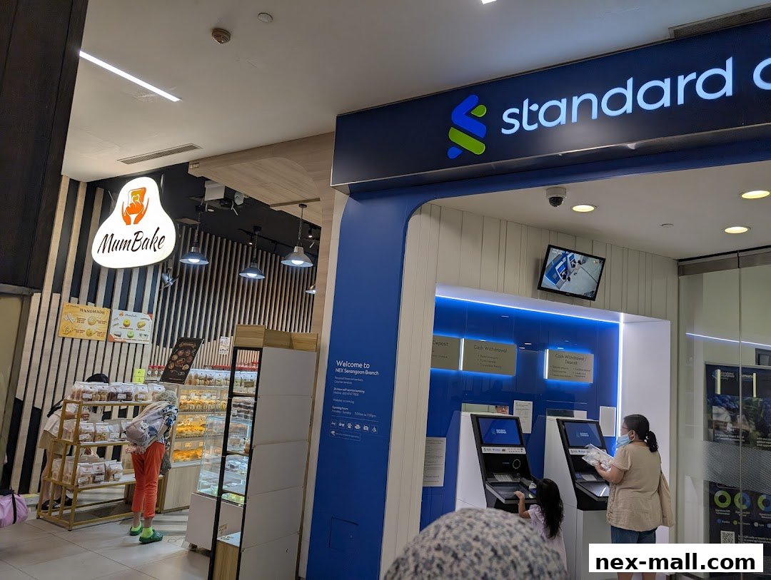 A Standard Chartered Bank ATM area next to a bakery shop called MumBake.