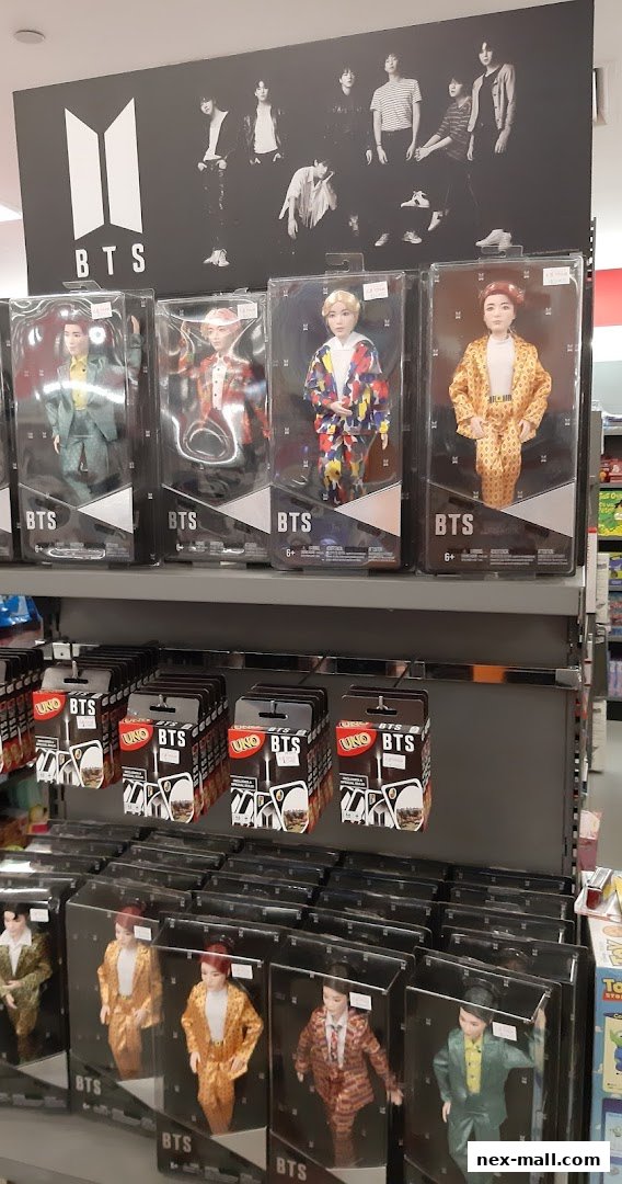 Display of BTS merchandise including dolls and UNO cards.