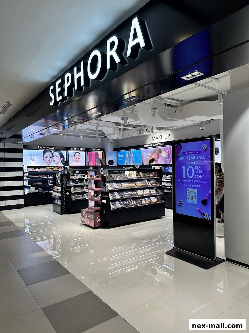 The entrance of a Sephora beauty store showcasing makeup products and a digital advertisement.