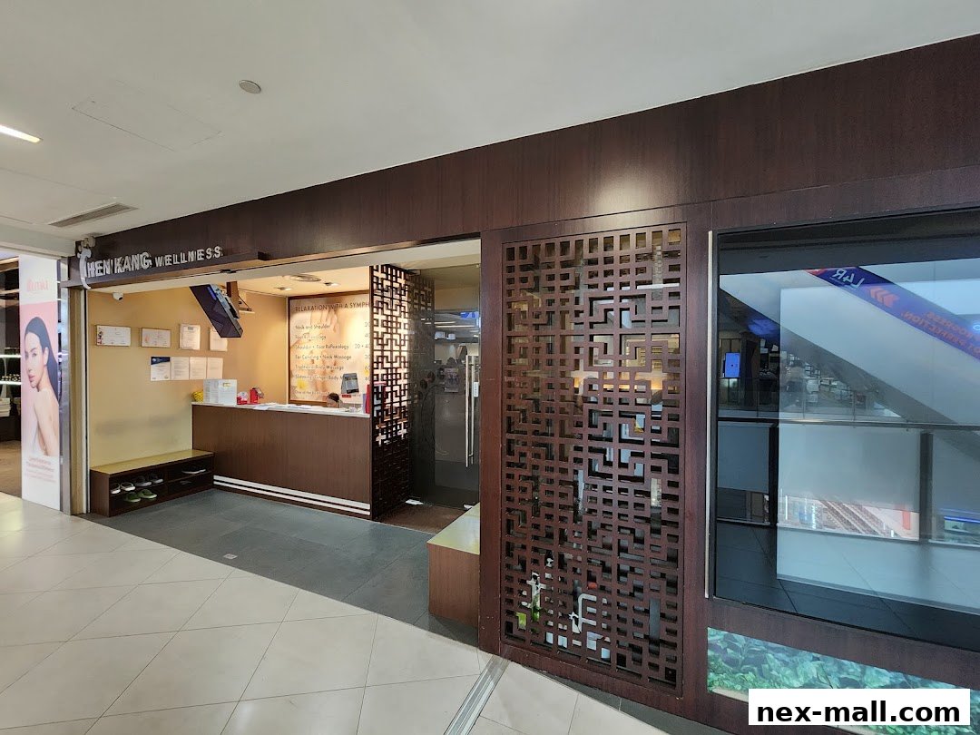 The entrance of Chen Kang Wellness, a spa and massage center, with a reception desk and service menu.