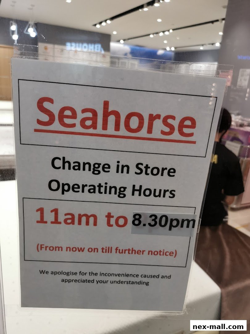 A sign announcing a change in operating hours for the Seahorse store.