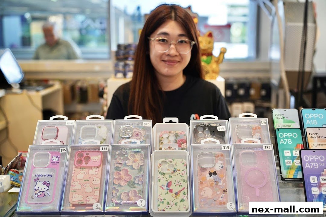 A smiling employee stands behind a display of phone cases and new OPPO phones.
