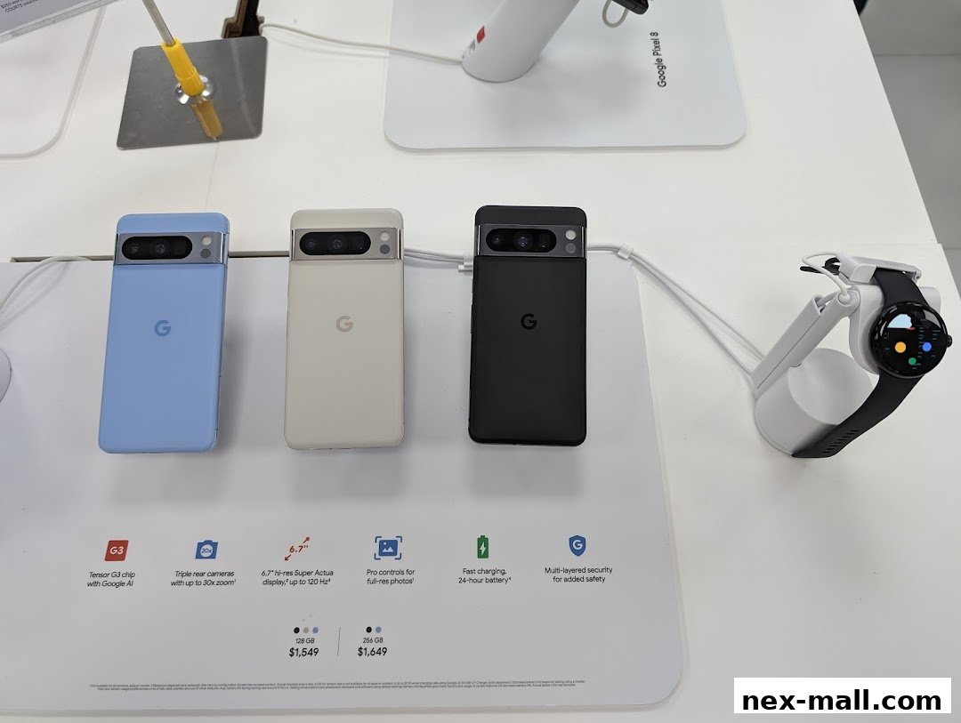 Google Pixel phones and a smartwatch displayed on a white counter with product information.