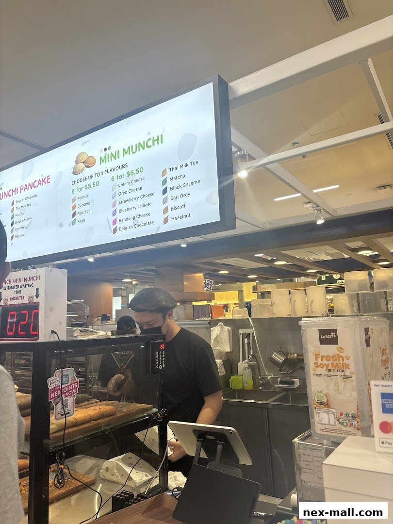 A menu board displays various pancake and drink flavors at Munchi Pancakes.