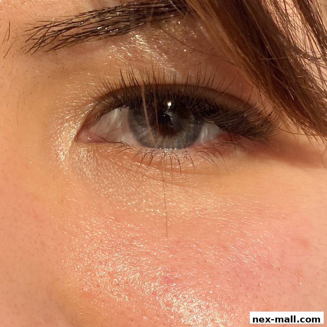 Close-up of a person's eye with long, voluminous eyelash extensions.