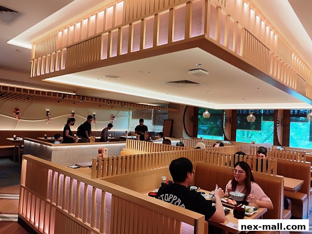 Interior view of a modern Japanese restaurant with diners seated at tables.