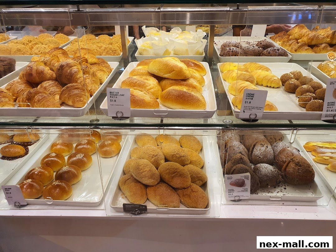 A display case filled with a variety of freshly baked breads and pastries.