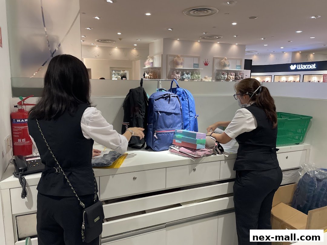 Two staff members are organizing merchandise at a counter in a retail store.