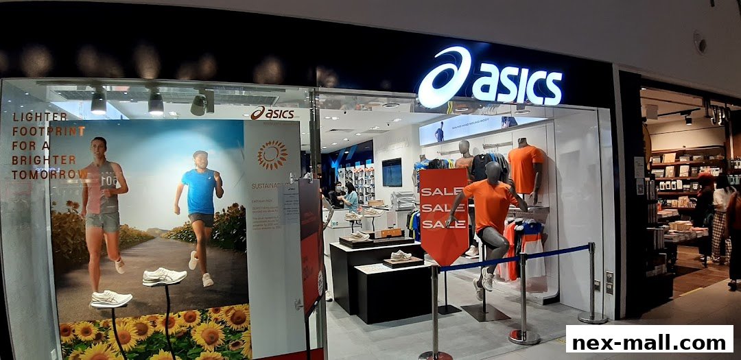 The Asics store features a large window display with runners and a sale sign, showcasing athletic wear and footwear.