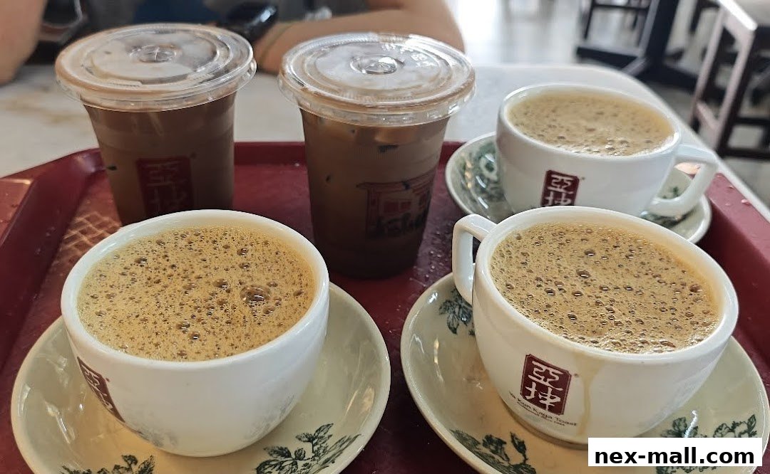 A tray with four cups of coffee and two iced coffee drinks from Ya Kun Kaya Toast.