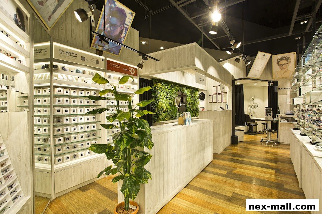 Interior view of a modern optical shop with displays of glasses and a reception area.