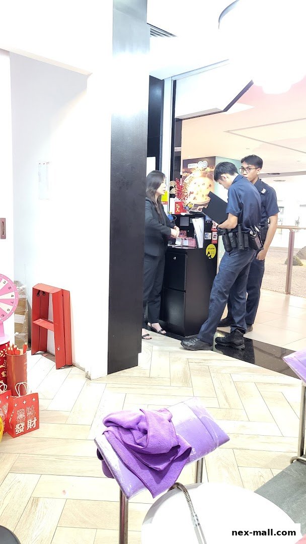 Staff interacting at a counter with promotional materials and a spinning wheel.