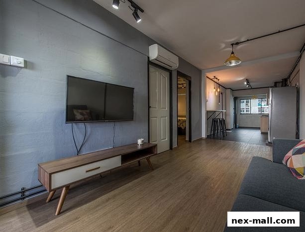 A modern living room with a TV, sofa, and a small dining area with stools.