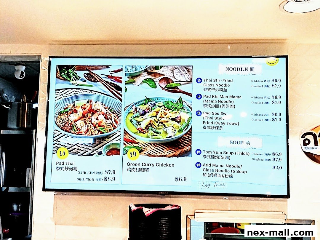 A digital menu board displaying various noodle and soup dishes with images and prices.