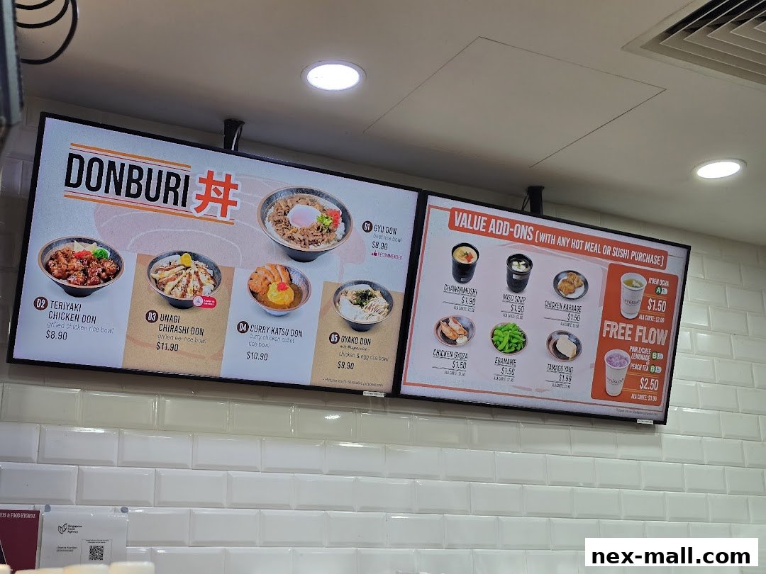 A digital menu board displaying various Donburi bowls and value-add-on items.
