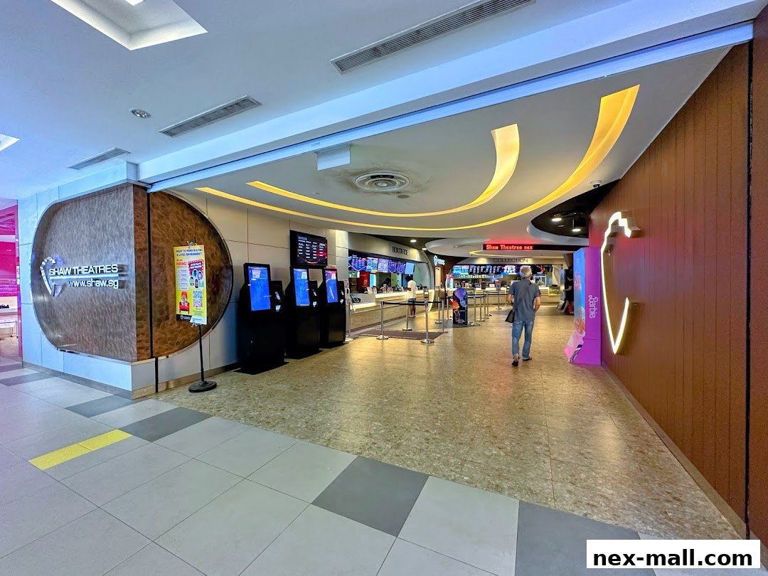 Interior view of Shaw Theatres NEX with ticket kiosks and a concession counter.