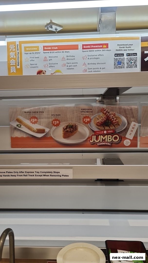 A display of sushi items and membership benefits at Genki Sushi.
