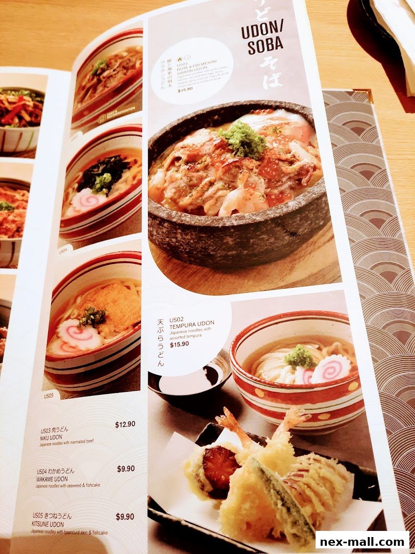 A menu from Ichiban Boshi NEX featuring various udon and soba dishes with appetizing food photography.