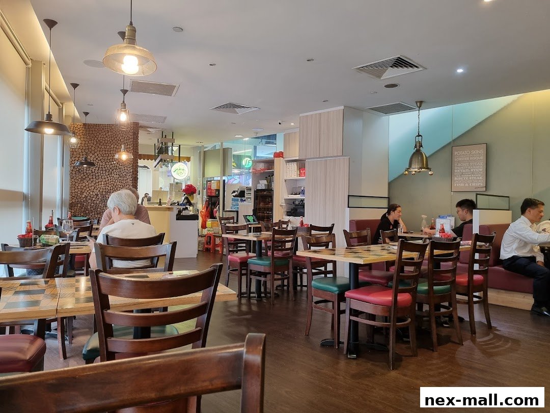 Interior of a restaurant with tables, chairs, and diners enjoying their meals.